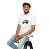 Man wearing a white t-shirt with a graphic design sitting on a stool against a white background