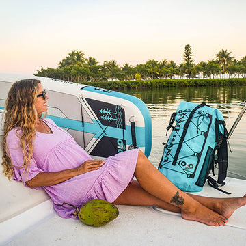 Sitting on a yacht next to a paddleboard and a coconut